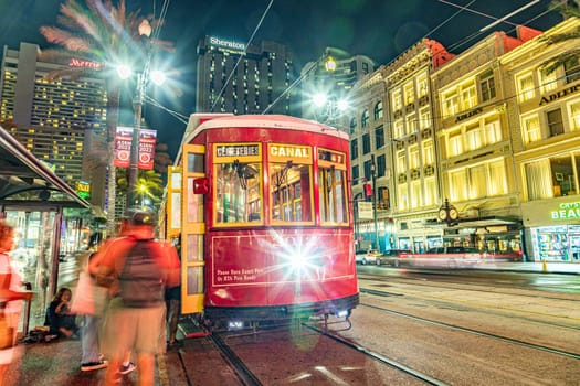 New Orleans, USA - October 24, 2023: people enter the red street car  at Canal street in New Orleans.
