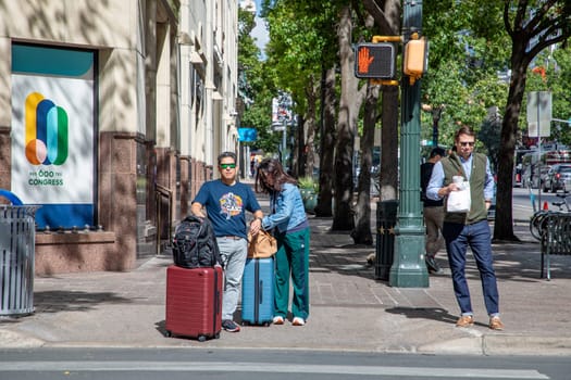 Austin, Texas - November 3, 2023:  people at a pedestrian crossing downtown Austin waiting for green light.