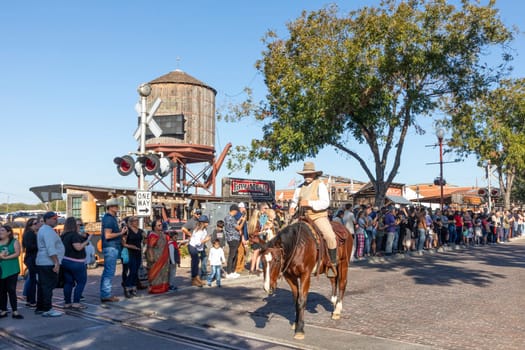 Fort Worth, Texas - November 4, 2023: people visit the stockyards train station located in the famous Stockyards and wait for the performance of longhorn cattle drive by cowboys.