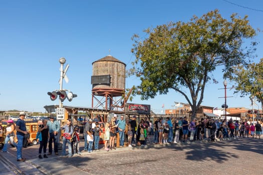 Fort Worth, Texas - November 4, 2023: people visit the stockyards train station located in the famous Stockyards and wait for the performance of longhorn cattle drive by cowboys.