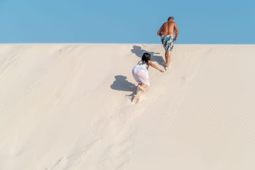 Atins, Brazil - December 23, 2023: people enjoy visiting the lagoa bonita - beautiful sea in the desert dune landscape Lencois Maranhenses National Park - Parque Nacional dos Lencois Maranhenses
