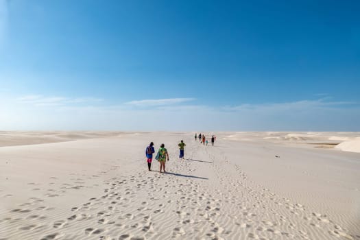 Atins, Brazil - December 23, 2023: people enjoy scenic desert dune landscape Lencois Maranhenses National Park - Parque Nacional dos Lencois Maranhenses.