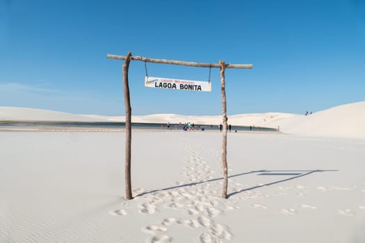Atins, Brazil - December 23, 2023: people enjoy visiting the lagoa bonita - beautiful sea in the desert dune landscape Lencois Maranhenses National Park - Parque Nacional dos Lencois Maranhenses