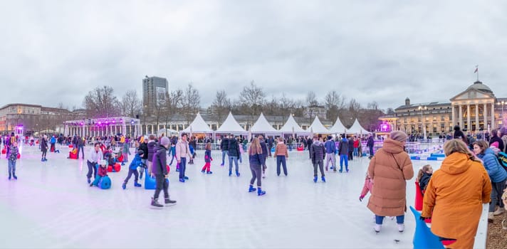 Wiesbaden, Germany - December 29, 2023: people enjoy the rink in front of the kurhaus in Wiesbaden, Hesse, germany.
