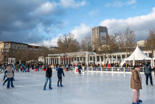 Wiesbaden, Germany - December 29, 2023: people enjoy the rink in front of the kurhaus in Wiesbaden, Hesse, germany.