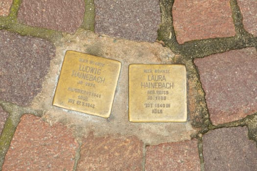 Seligenstadt, Germany - Januar 5, 2024: Stolpersteine project, stumbing stones on the pavement in front of former home of family Hainebach.