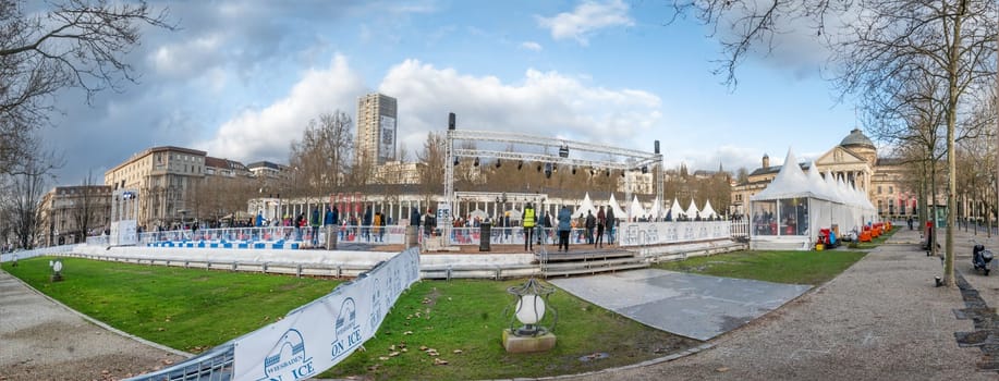 Wiesbaden, Germany - December 29, 2023: people enjoy the rink in front of the kurhaus in Wiesbaden, Hesse, germany.