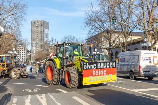 Wiesbaden, Germany - January 8, 2024: farmer with their tractors demonstrate for cutting down the price for diesel fuel and against the german government with poster ohne Farmer keine Zukunft - engl. no future without farmers.