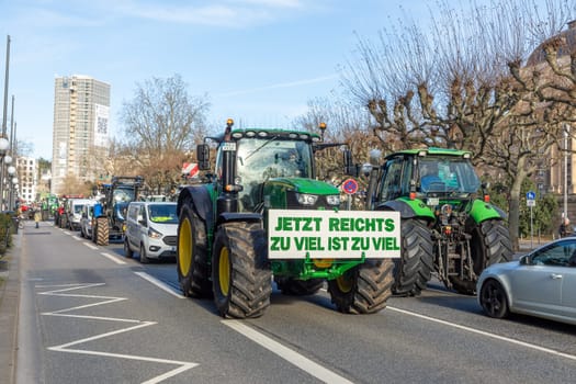 Wiesbaden, Germany - January 8, 2024: farmer with their tractors demonstrate for cutting down the price for diesel fuel and against the german government with poster enough is enought - Jetzt reichts zu viel ist zuviel