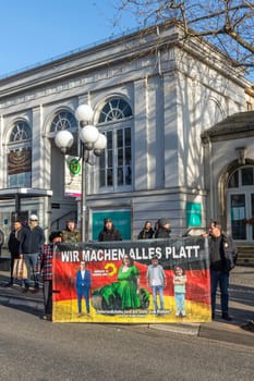 Wiesbaden, Germany - January 8, 2024: farmer with their tractors demonstrate for cutting down the price for diesel with poster wir machen alles kaputt - engl we destroy everything.