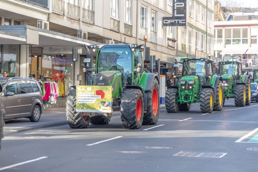 Wiesbaden, Germany - January 8, 2024: farmer with their tractors demonstrate for cutting down the price for diesel fuel and against the german government with poster for climate change goals.