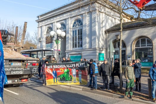 Wiesbaden, Germany - January 8, 2024: farmer with their tractors demonstrate for cutting down the price for diesel with poster wir machen alles kaputt - engl we destroy everything.