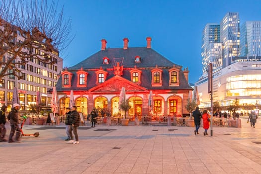 Frankfurt, Germany - February 2, 2024: scenic  view to Hauptwache in red light - guard house - in dawn in Frankfurt.