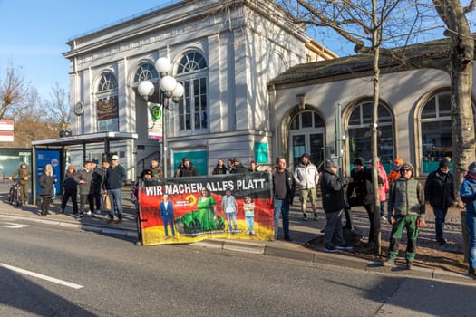 Wiesbaden, Germany - January 8, 2024: farmer with their tractors demonstrate for cutting down the price for diesel with poster wir machen alles kaputt - engl we destroy everything.
