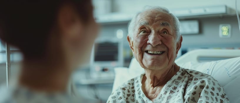 An elderly man in a hospital gown beams with a broad smile during a pleasant conversation. The warmth of the exchange fills the hospital room