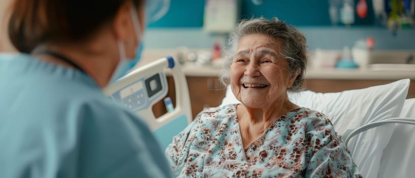 A senior woman's warm smile fills the hospital room as she chats with a caregiver, her spirit undiminished by her surroundings