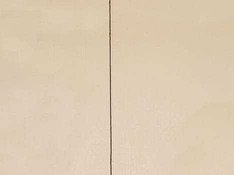 Background texture of a brown wall with a vertical straight crack in close-up