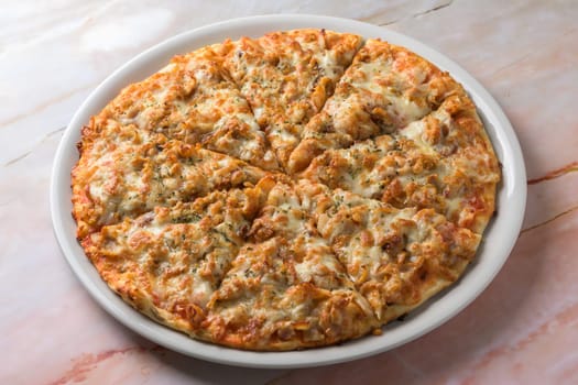 BBQ CHICKEN pizza isolated on cutting board top view on dark background italian fast food