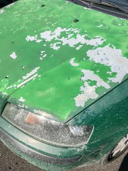 Cracked and peeling paint on an old car for background.