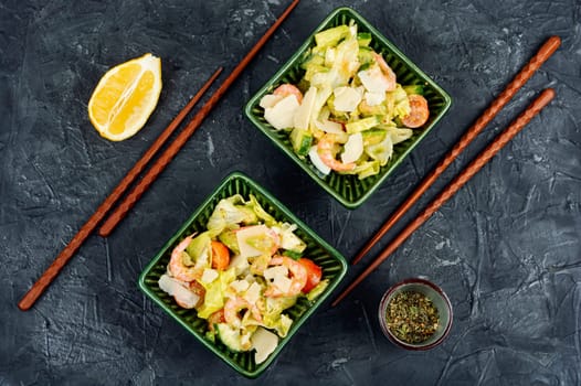 Asian salad with shrimp,prawns avocado and tomato in a bowl. Healthy food concept.