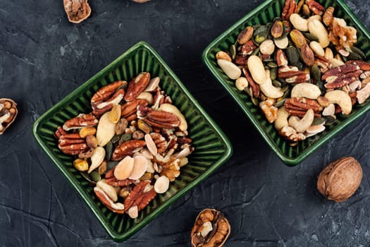 Mix of various nuts, pistachios, cashews, walnuts, peanuts and brazil nuts. Vegetarian food concept.