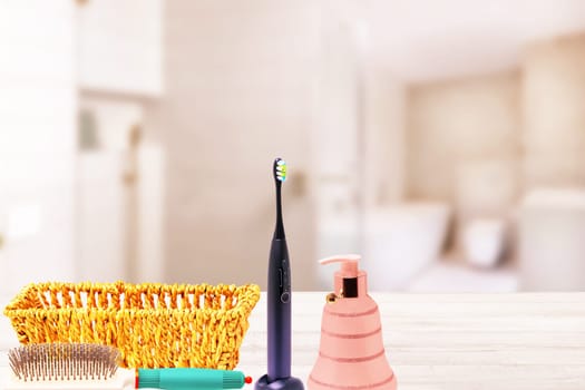 Bath accessories of female cosmetics for healthy look and a empty basket on table over abstract blurred bathroom. Beauty and Wellness concept. Copy space.