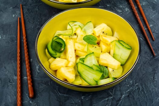 Asian vegan salad with pineapple, nuts and cucumber in a bowl. Weight loss concept.
