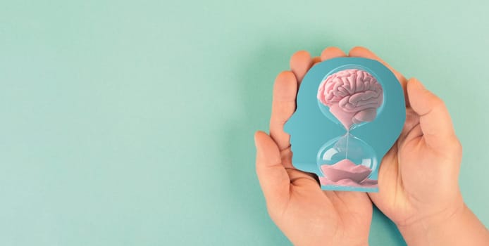 Human mind, mental health and psychology concept, dementia or Alzheimer disease, brain memory loss, lifetime running through hourglass