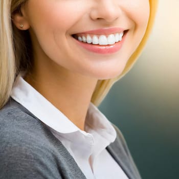 Dental health concept: woman smiling close up. Isolated on white.
