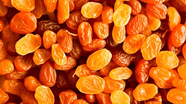 Close-up of a heap of shiny dried apricots, basking in natural light.