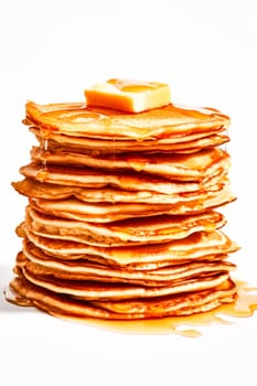 A tall stack of golden pancakes topped with a pat of butter and drizzled with syrup.