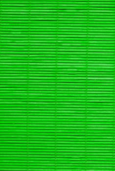 Green wooden vertical mat for hot food close-up view from above