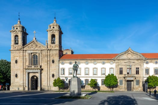 Braga, Portugal - May 1, 2023: Statue of Gomes da Costa, a former president of Portugal in 1920 with the hall of the people in background in sunrise