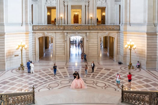 San Francisco, USA - June 7, 2022: wedding couple poses for photos inside the city hall of San Francisco.