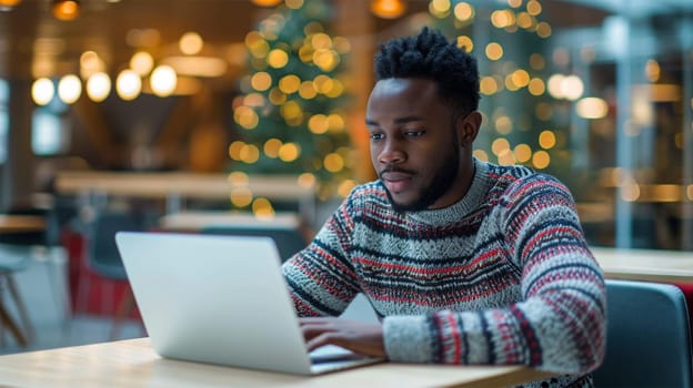 A man in business casual attire engrossed in his laptop at a well-lit restaurant, a scene of remote work lifestyle.