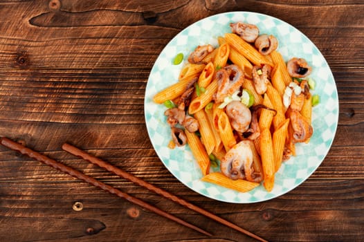 Appetizing macaroni or pasta boiled with octopus. Pasta with seafood.