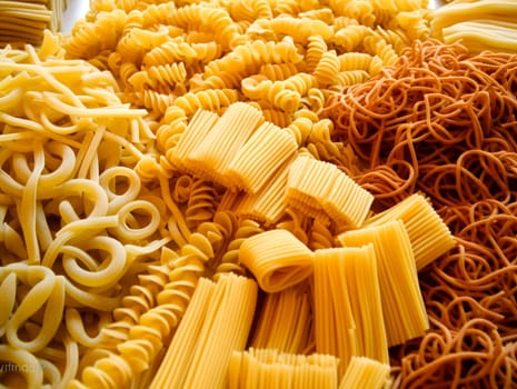 An array of uncooked pasta types with vibrant color and varied shapes.