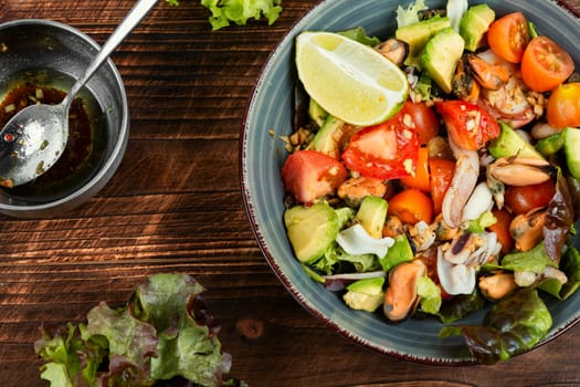 Seafood salad with shrimp, octopus, mussels, tomatoes, avocado and mixed greens