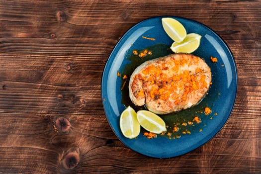 Grilled salmon or trout steak with orange and lime sauce. Space for text.