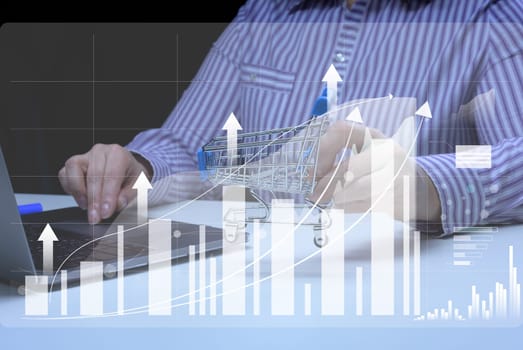 Woman sits at a laptop in front of a holographic chart with growing indicators. Business development, high financial performance, success.