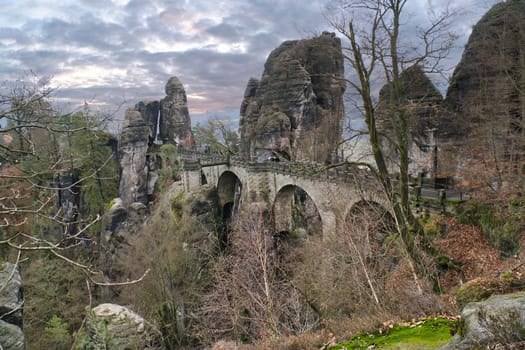 The Bastei Bridge in Saxon Switzerland. jagged rocks, viewing platform overlooking the Elbe. Tourist attraction. Dramatic sky. National park in Germany