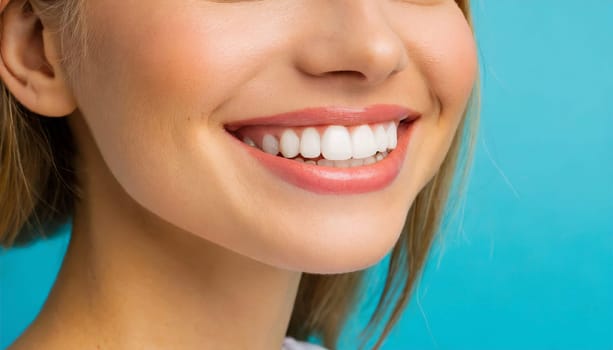 dental care concept for dentists and orthodontist - close up of a woman with a smile and perfect white teeth