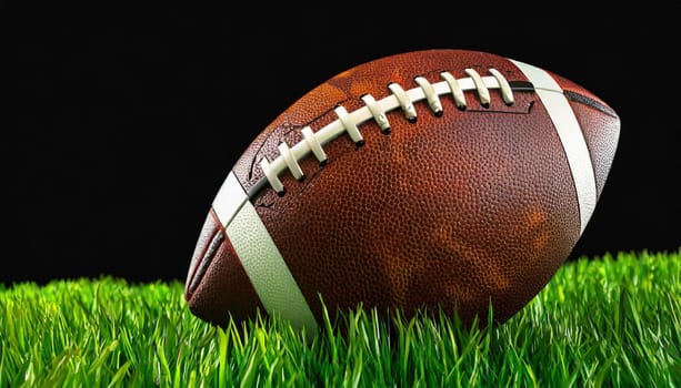 American football on green grass, on black background