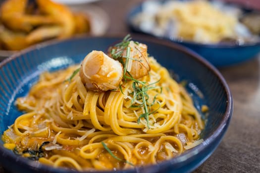 Pasta with scallop dish in restaurant