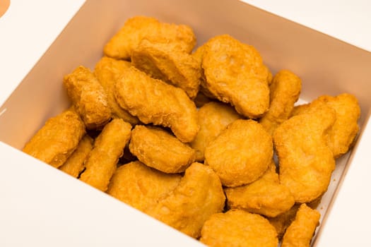Golden deep fired chicken nugget in paper box