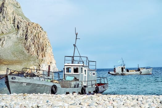Boat on the shore of Lake Baikal, coastal landscape.
