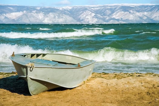 Boat on the shore of Lake Baikal, coastal landscape.