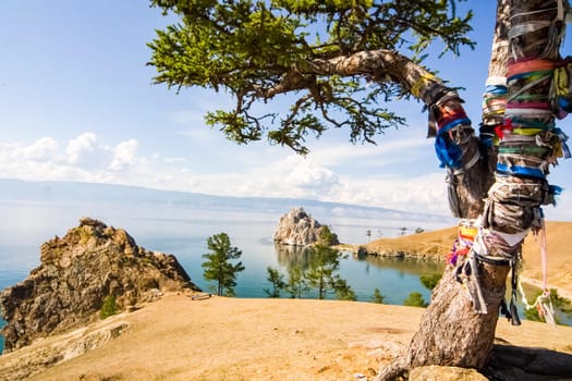 Colored ribbons on trees and pillars, superstition for good luck, Baikal traditions.