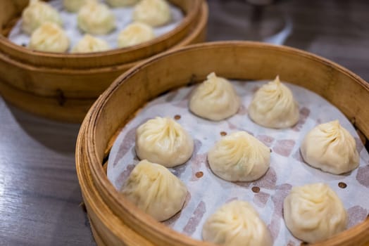 Steamed xiaolongbao served in a traditional steaming basket