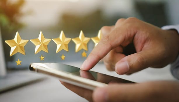 close up on customer man hand pressing on smartphone screen with gold five star rating feedback icon and press level three rank (good) for give score point to review the service business concept